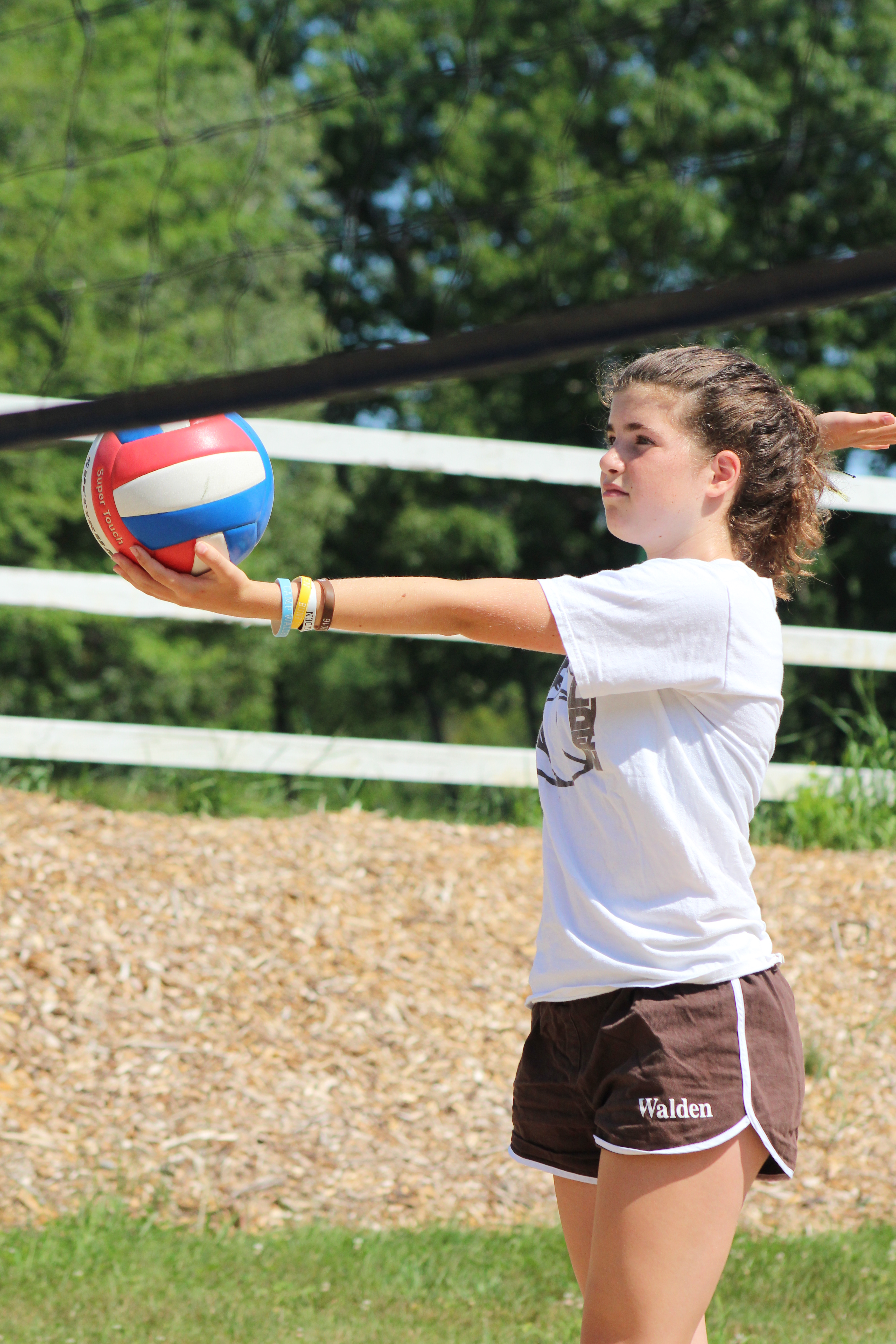 Girl practices her volleyball serve