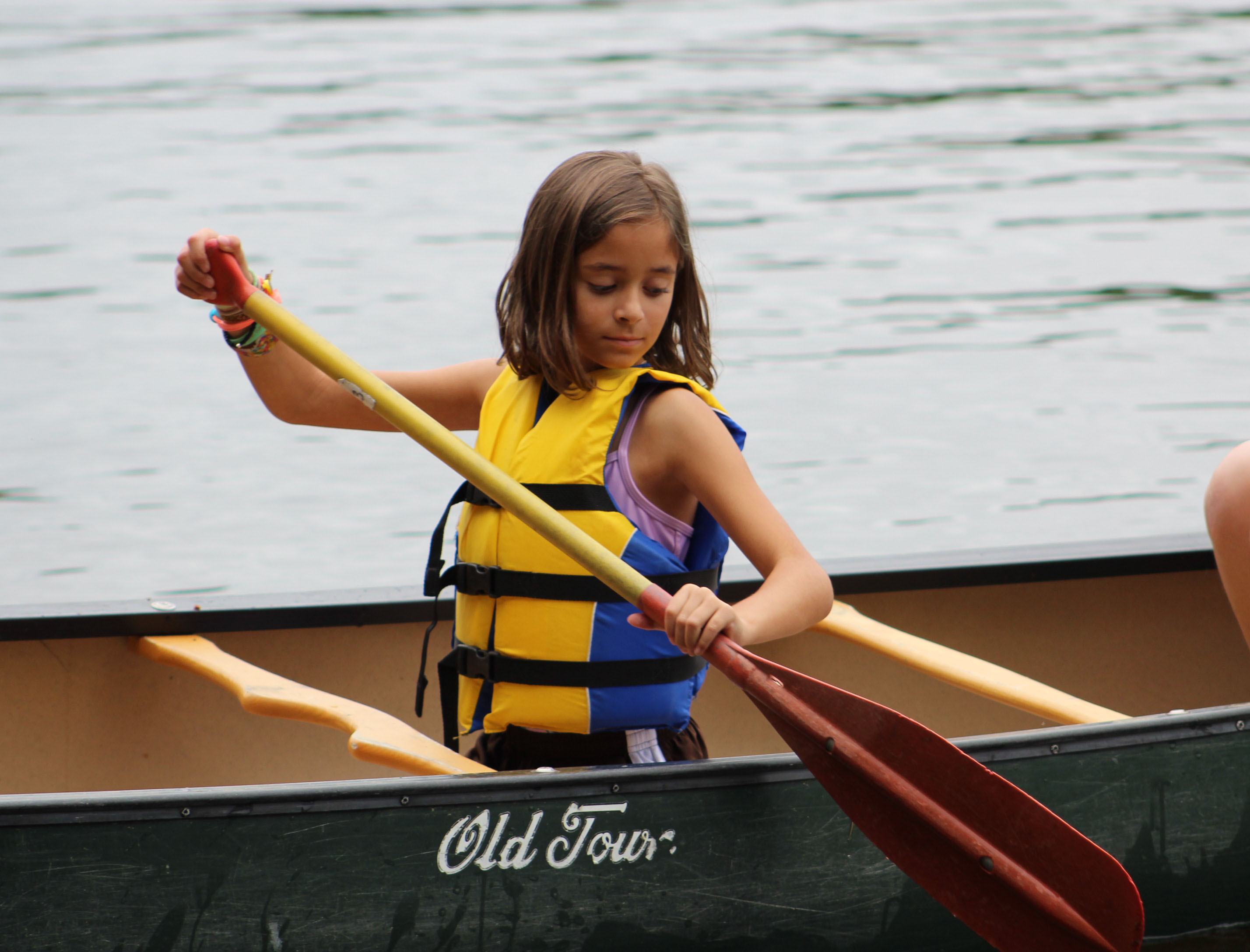 Girl paddles her canoe