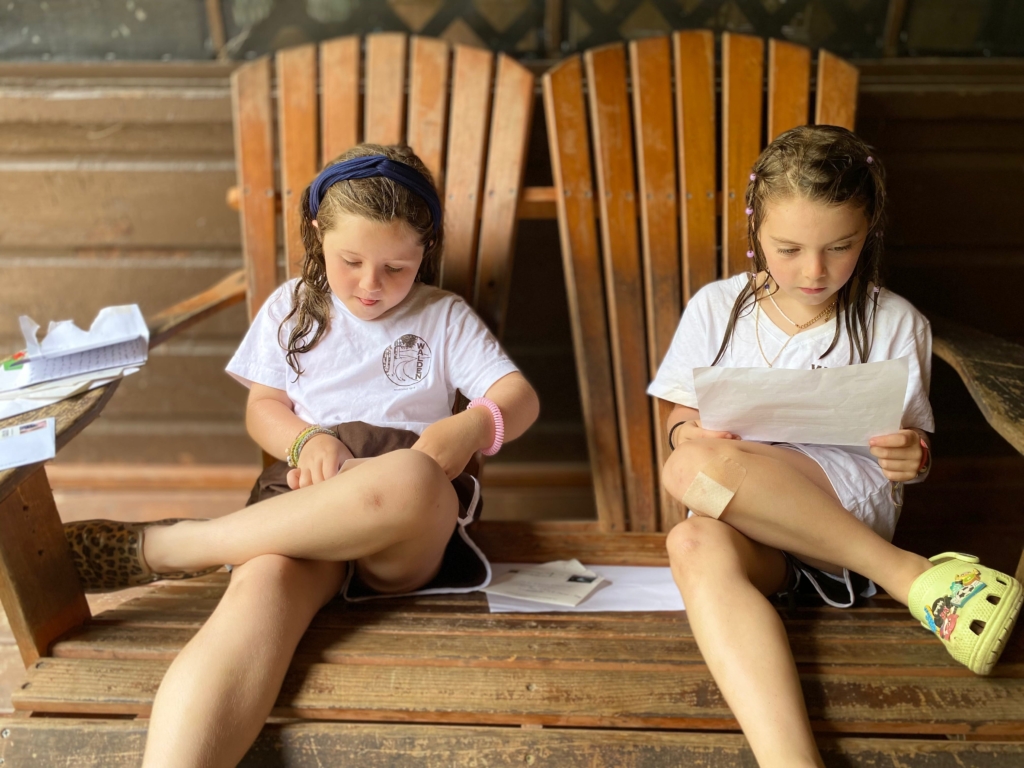 Campers take a moment to read mail from home