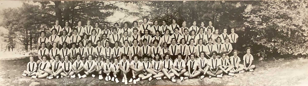 Historic scene from Camp Walden of all campers sitting together in a group photo.