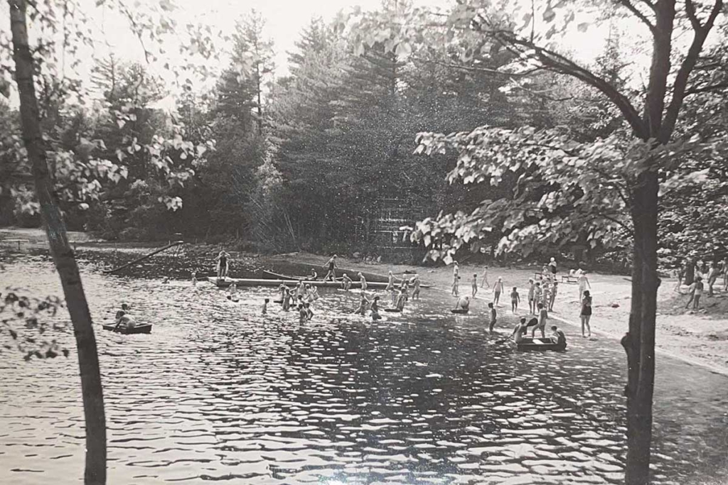 Historic scene from Camp Walden of swimming campers at the lake.